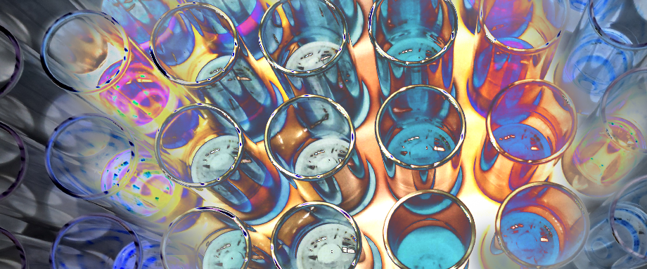 A stand of liquid-filled beakers glows colorfully