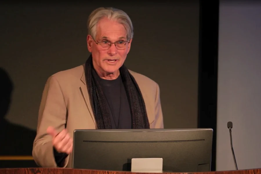 Elliot Marseille at podium presenting at 2025 Psychedelic Symposium